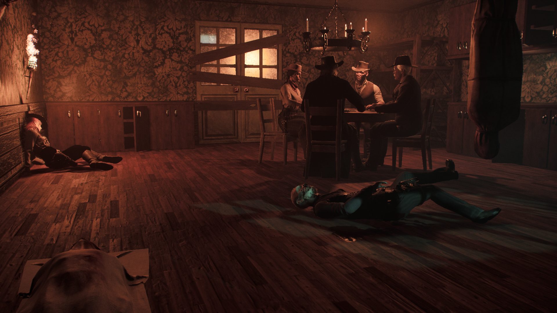 Four outlaws playing cards by candlelight in a wood-panelled room, with three bodies laid out on the floor around the table.